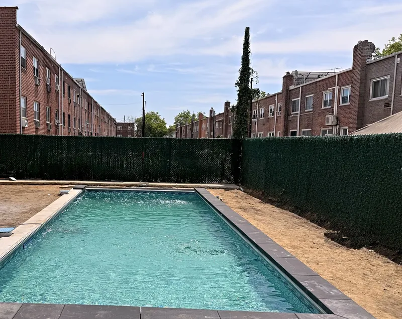 Finished pool filled, with dark charcoal coping