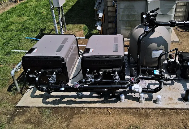 Finished pad – two Hayward gas heaters, sand filter and Schedule 80 manifold