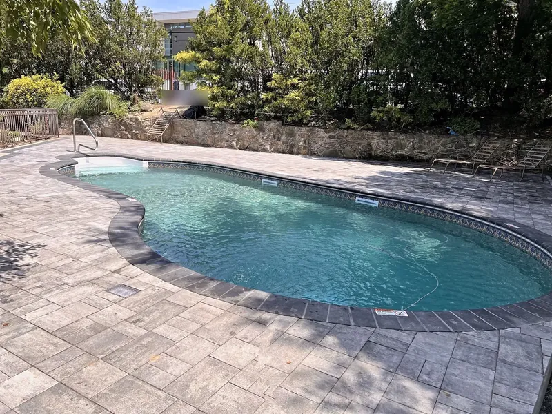 Finished pool with new liner, paver coping and gray paver patio