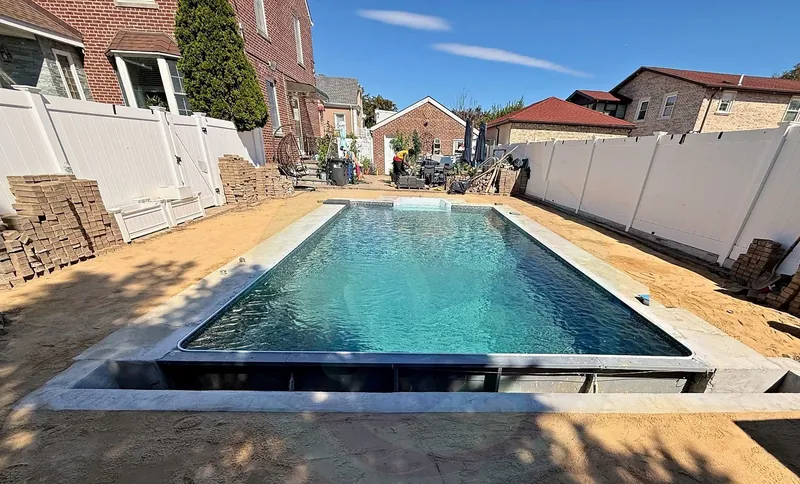 Rebuilt pool filled, with new coping and liner